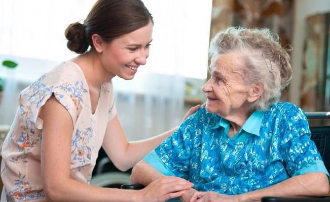 Caregiver interacting with a resident in a bright room