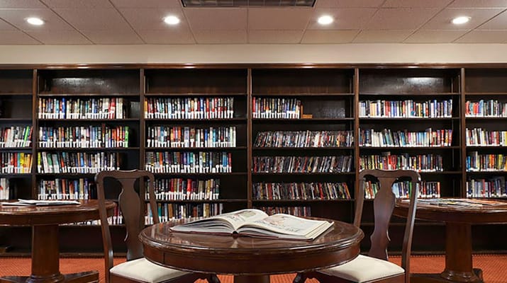 Interior view of a library with bookshelves and tables