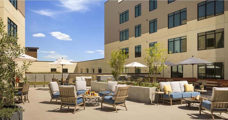 Outdoor seating area with lounge chairs and umbrellas