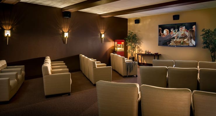 Cozy movie theater room with seating and a screen