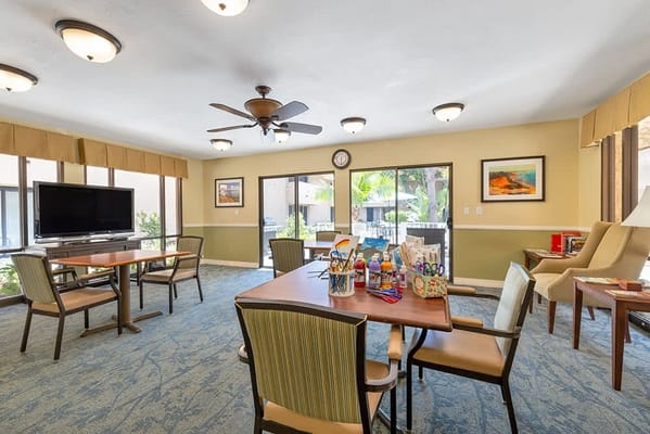 Bright common area with tables and chairs.