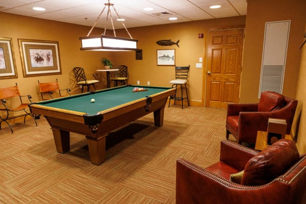 Billiards room with a pool table and seating area