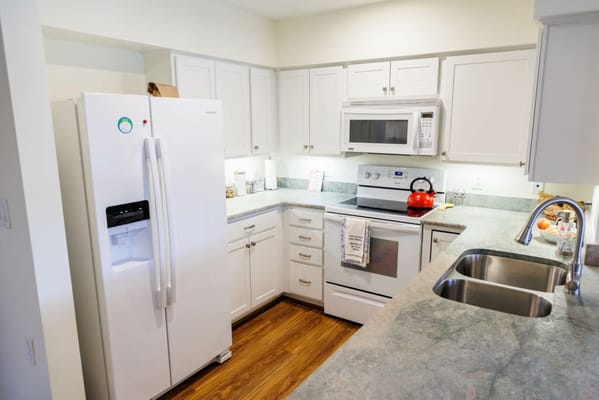 Spacious kitchen with modern appliances and wooden flooring