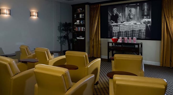 Cozy movie theater with leather seating and a large screen