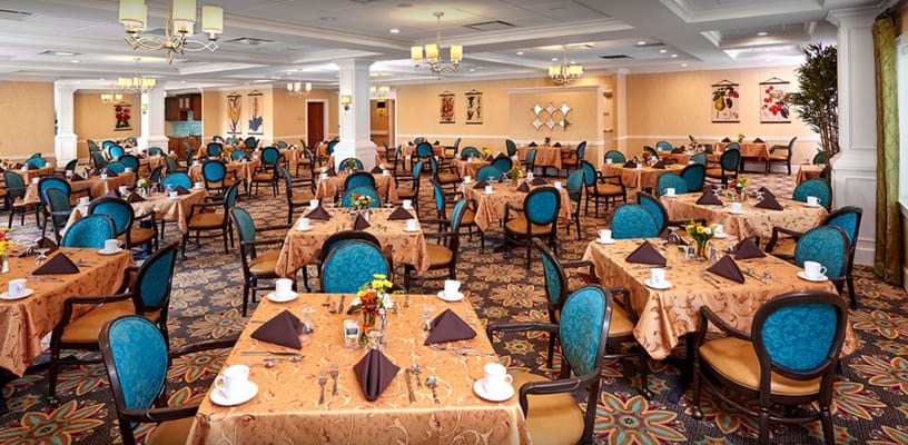 Spacious dining room with tables set for a meal