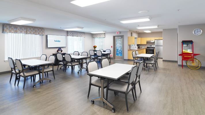 Bright activity room with tables and chairs