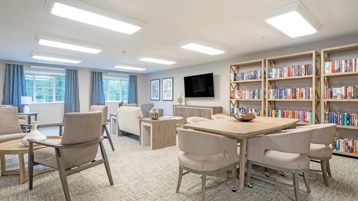 Bright common area with seating and bookshelves