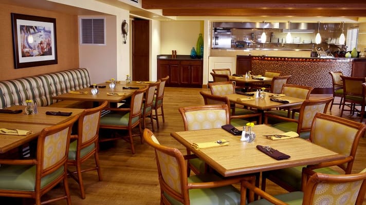 Bright dining room with wooden tables and cozy seating