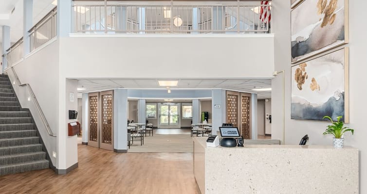 Modern reception area with stairs and seating.