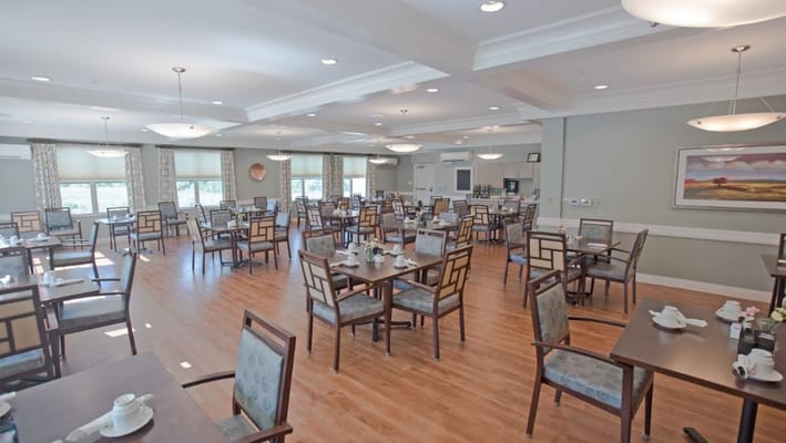 Bright dining room with tables set for meals