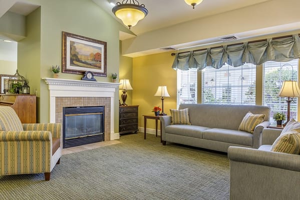 Bright common area with comfortable seating and a fireplace
