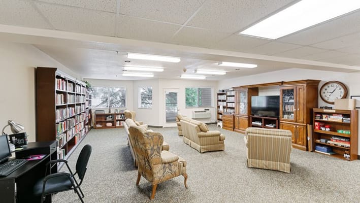 Bright common area with seating and bookshelves