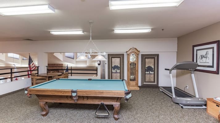 Common area with pool table and treadmill