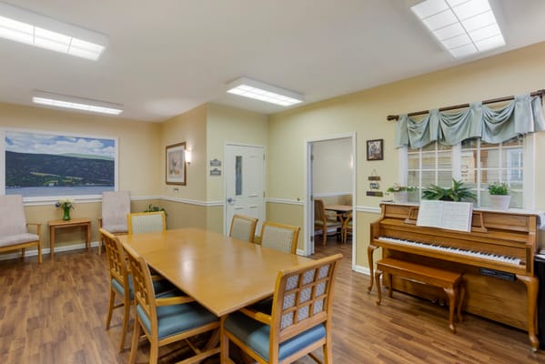 Common area with a dining table and piano