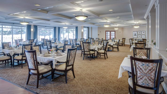 Elegant dining room with tables set for meals