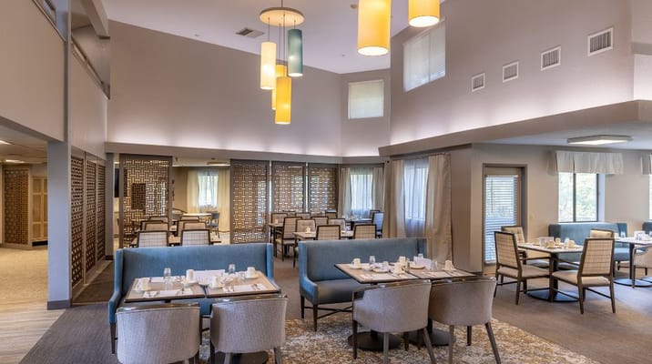 Bright and inviting dining room with tables set for meals