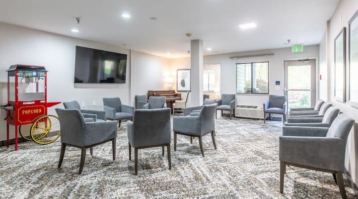 A cozy common area with seating and a popcorn machine