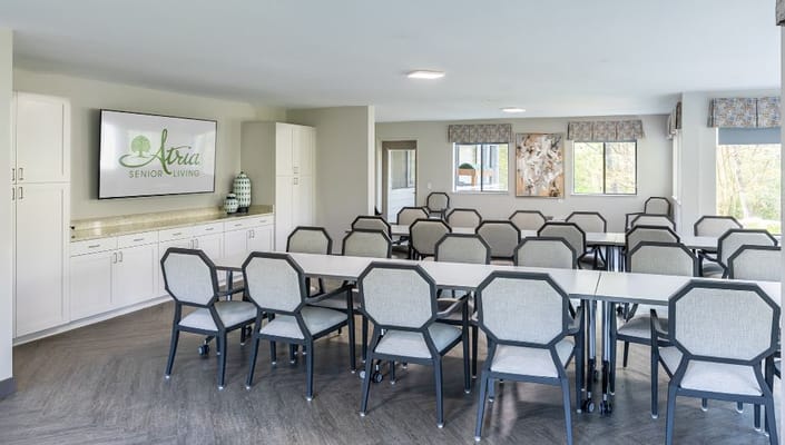 Bright activity room with tables and chairs