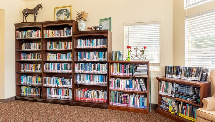 Bookshelves filled with a variety of books in the Jackson Meadow library.
