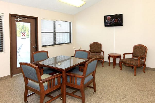 Bright common area with a table and chairs