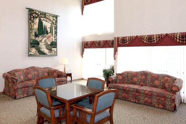 Interior common area with floral sofas and a table