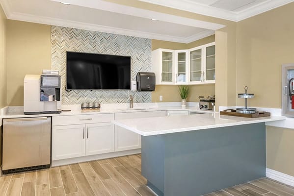Modern kitchen area with seating and appliances