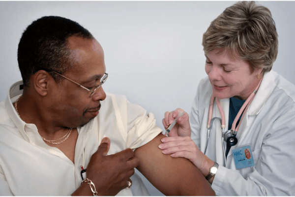 A healthcare professional administering a vaccine to a patient.