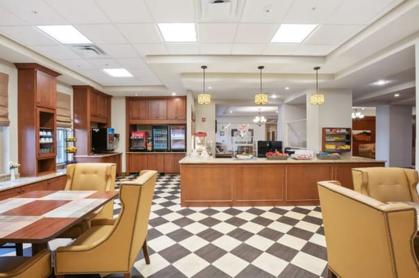 Interior view of a dining area with seating and kitchen