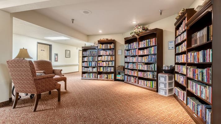 A cozy library area with bookshelves and seating