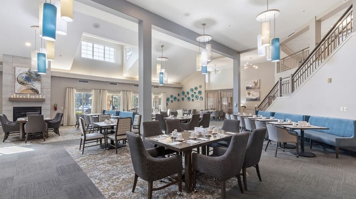Spacious dining room with tables set for a meal