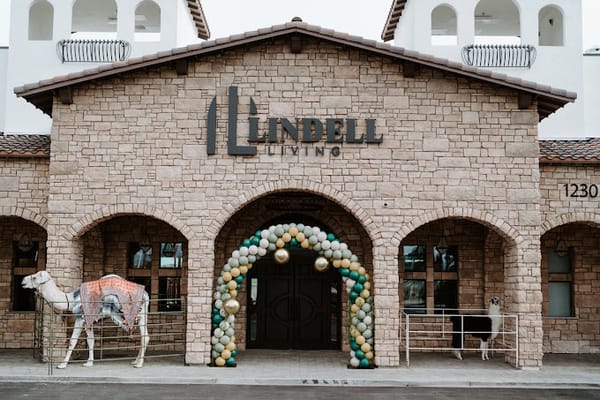 Exterior view of Lindell Living entrance with logo