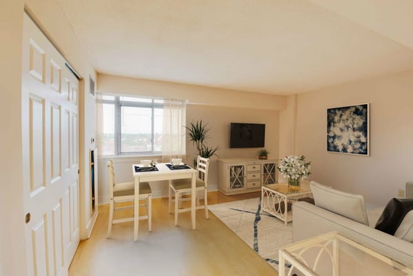Brightly lit living room with dining area at Linden Park Apartments