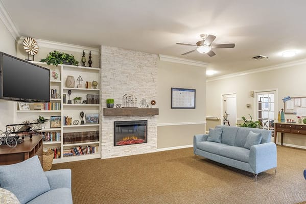 Bright interior common area with seating and fireplace