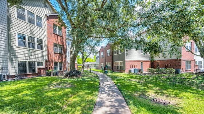Lush outdoor path between residential buildings