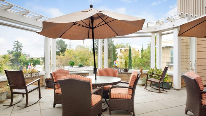 Outdoor patio area with tables and umbrellas