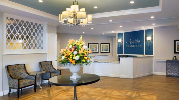Bright interior lobby with floral arrangement and seating