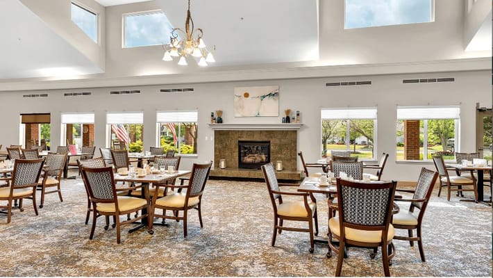 Spacious dining area with tables and chairs in Holiday Blue Water Lodge.