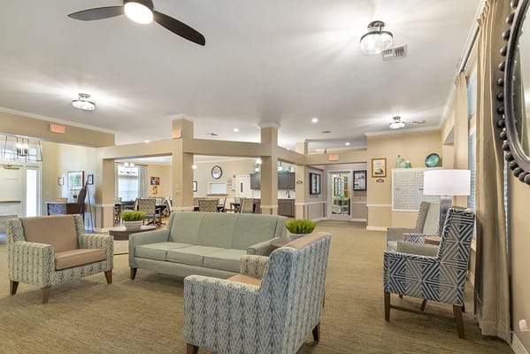 Common area with seating and decor in a senior living facility