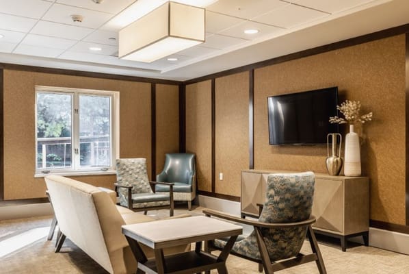 Bright common area with seating and television