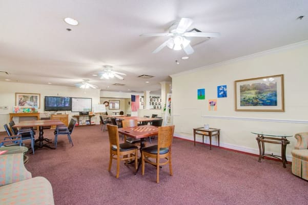 Spacious common area with seating and activity tables