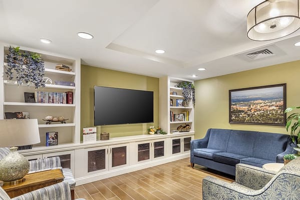 Cozy common area with seating and a large TV