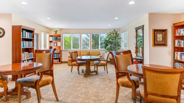 Comfortable reading area with tables and bookshelves.