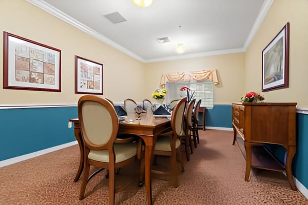 A well-furnished common area with a dining table