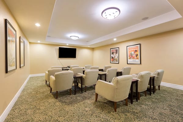 Cozy game room with seating and TV at Mountain Park Senior Living