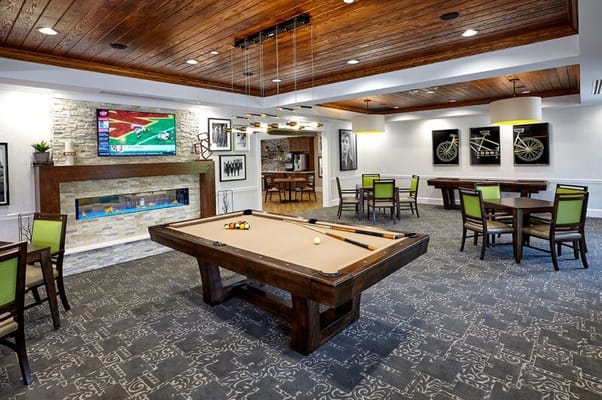 Interior common area with a pool table and seating.