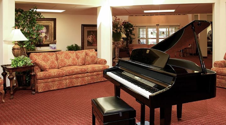 Piano in a cozy common area with seating