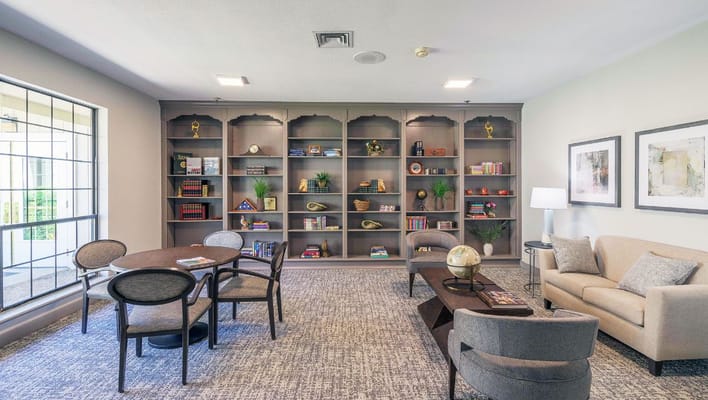 Comfortable common area with bookshelves and seating
