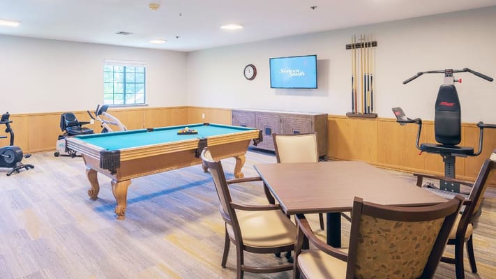 Common area with a pool table and exercise equipment