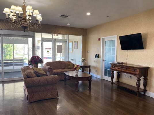 Cozy living room with decorative chandelier, couches, and a coffee table