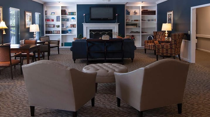 Cozy lounge area with seating and bookshelves